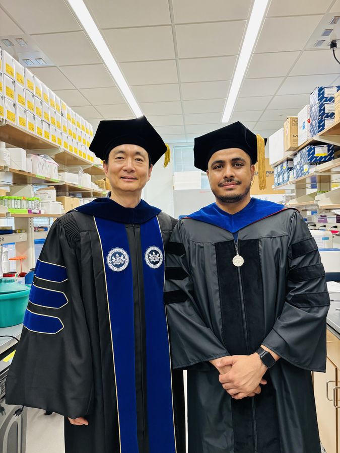 Deependra Paneru in doctoral regalia with his advisor